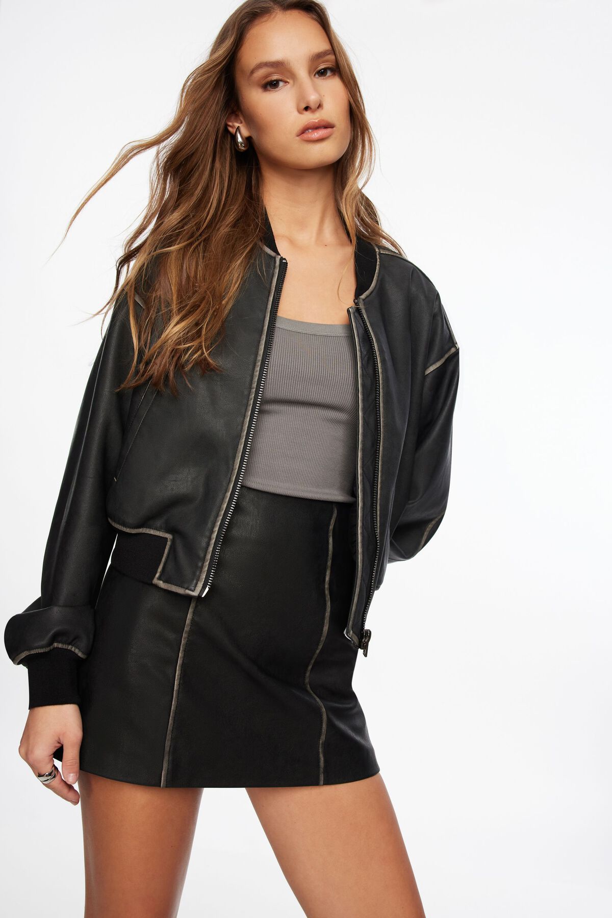 black mock neck tank top with black leather jacket and jeans
