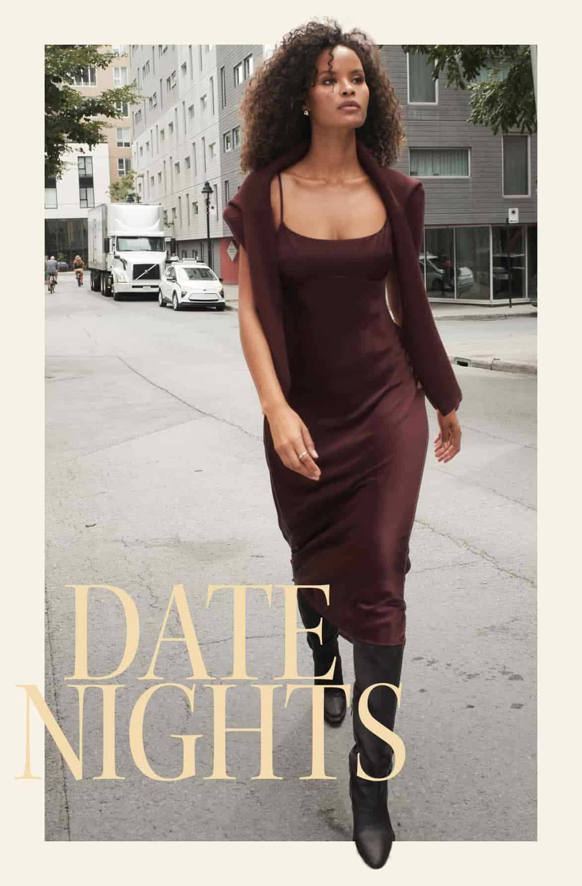 Model is wearing a burgundy cardigan over a burgundy satin maxi dress.