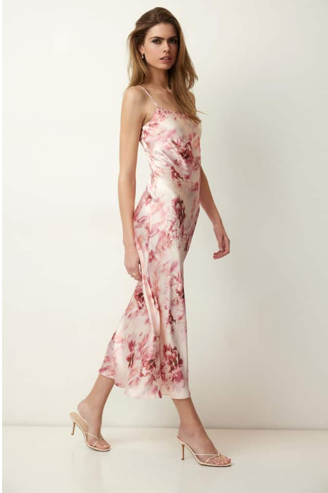 Model is wearing a pink floral satin maxi dress.