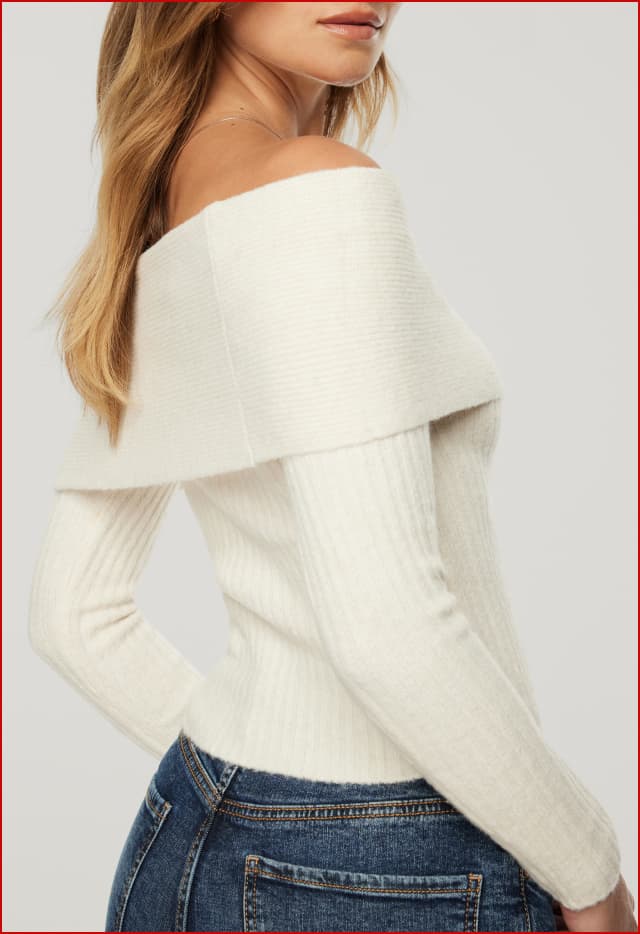 Model is wearing an off-white off shoulder sweater.