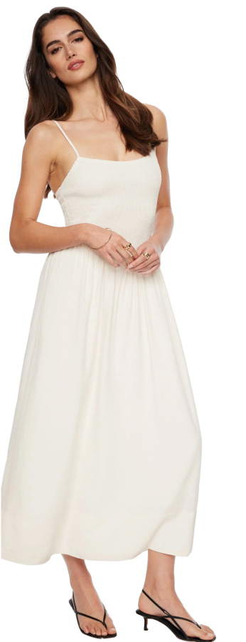 Model is wearing a white linen maxi dress.