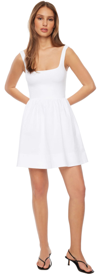Model is wearing a white flare mini dress.