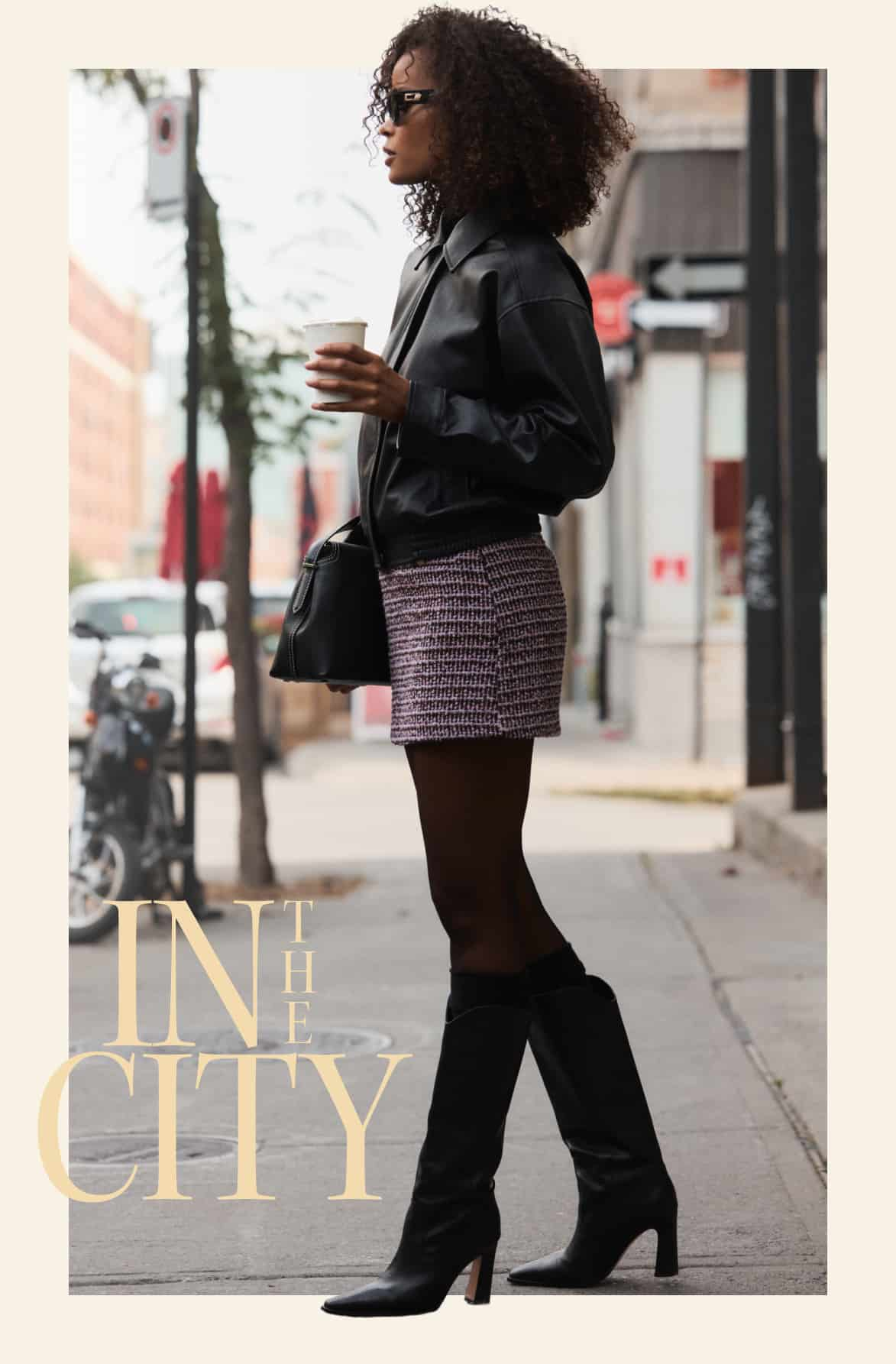 Model is wearing a black faux leather jacket with a purple tweed mini skirt and sheer tights.